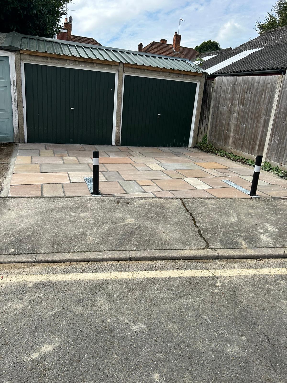 Block-paved driveway with garage bollards