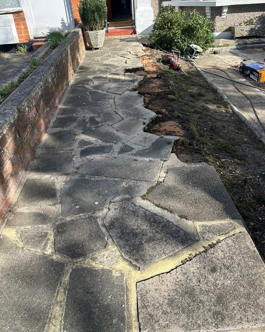 Cracked crazy paving patio before replacement