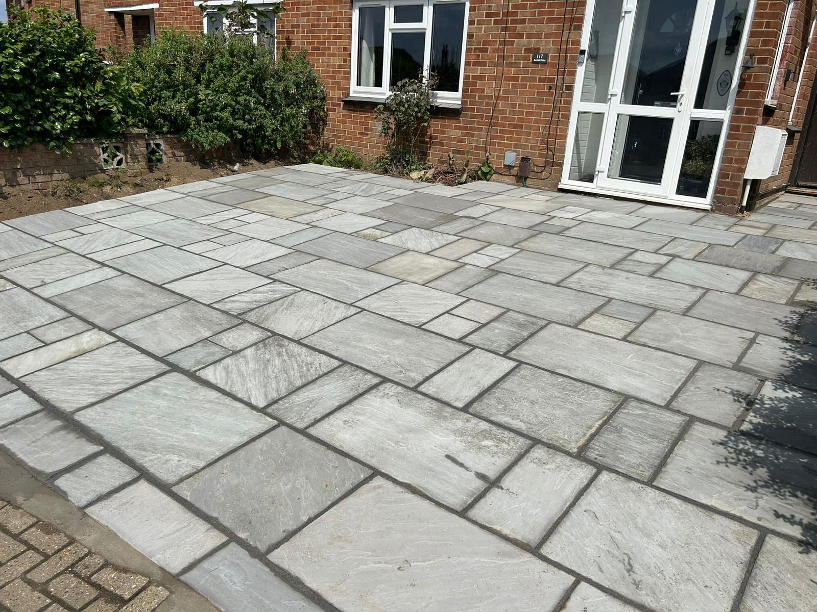 Grey sandstone patio with crisp pointing
